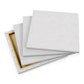 Stack of blank white canvas panels with wooden frames for painting and art projects
